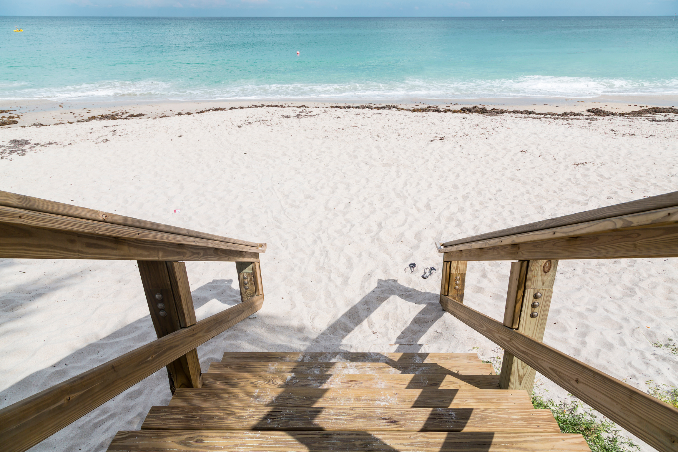 Green chairs and blue summer beach house.